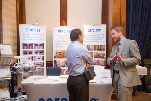 Aerolase rep speaking with attendee
